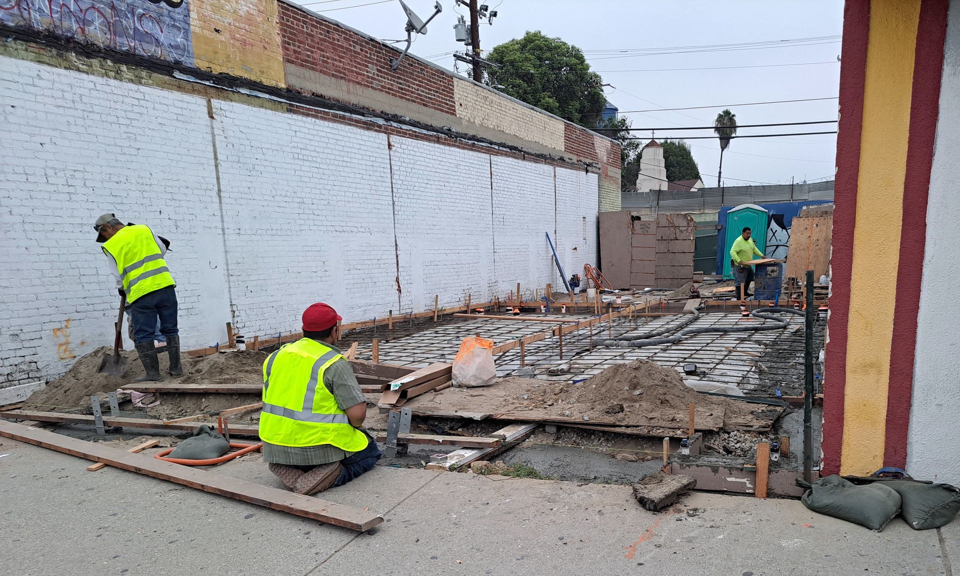 A group of construction workers are working on a building.