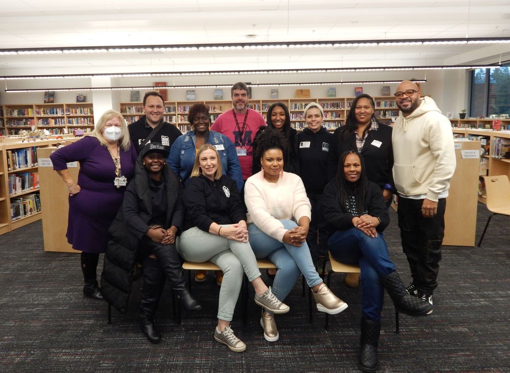 A group of people are posing for a picture in a library.