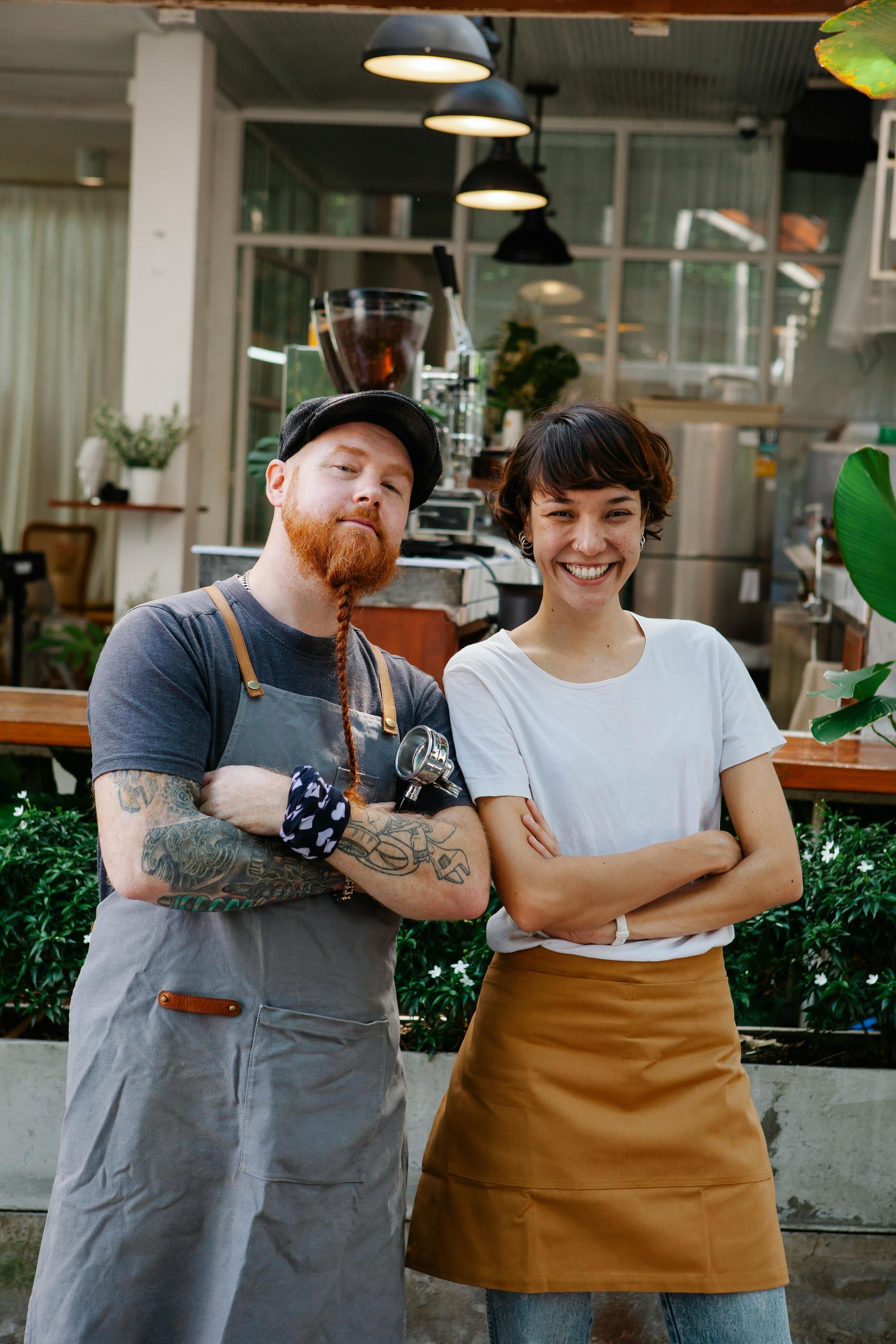 A man and a woman are standing next to each other in front of a restaurant.