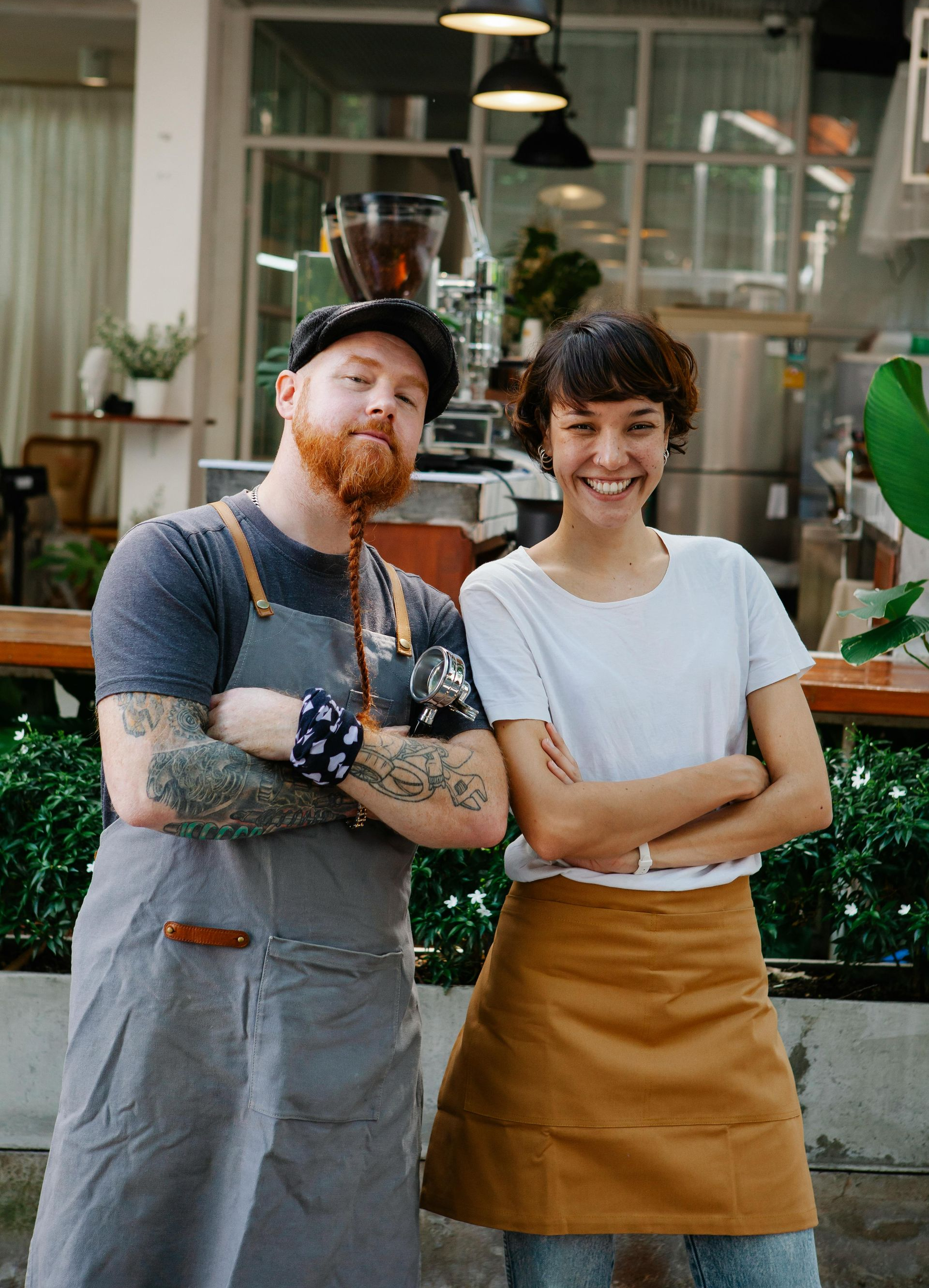 A man and a woman are standing next to each other in front of a restaurant.