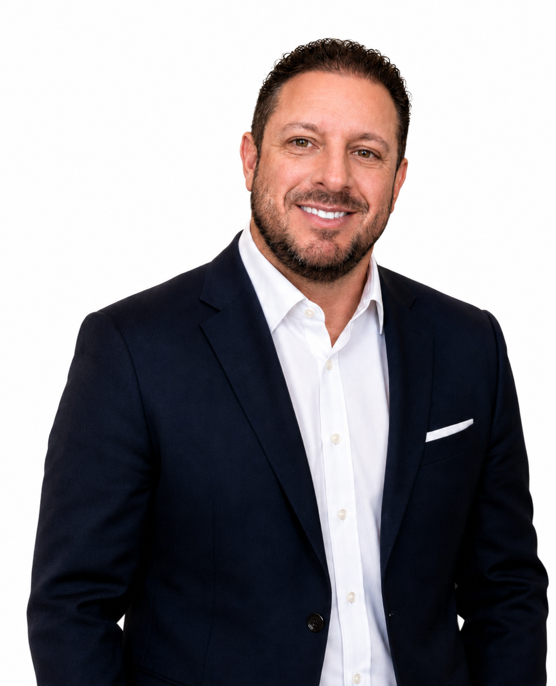 Man in blue suit, buttoning jacket, smiling, neutral background.