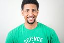 Smiling person wearing a green shirt with the word 
