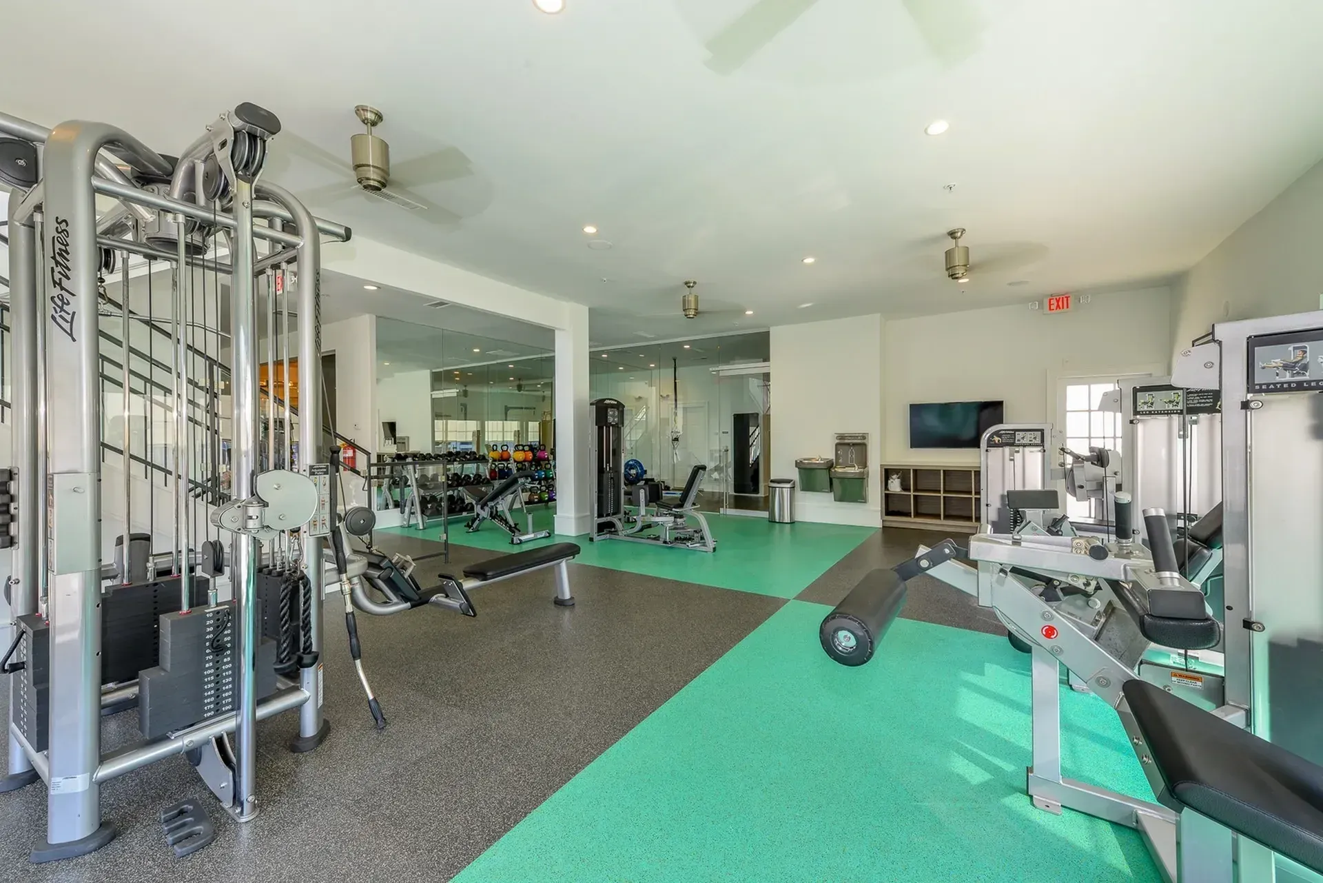 Gym with weight machines and free weights.