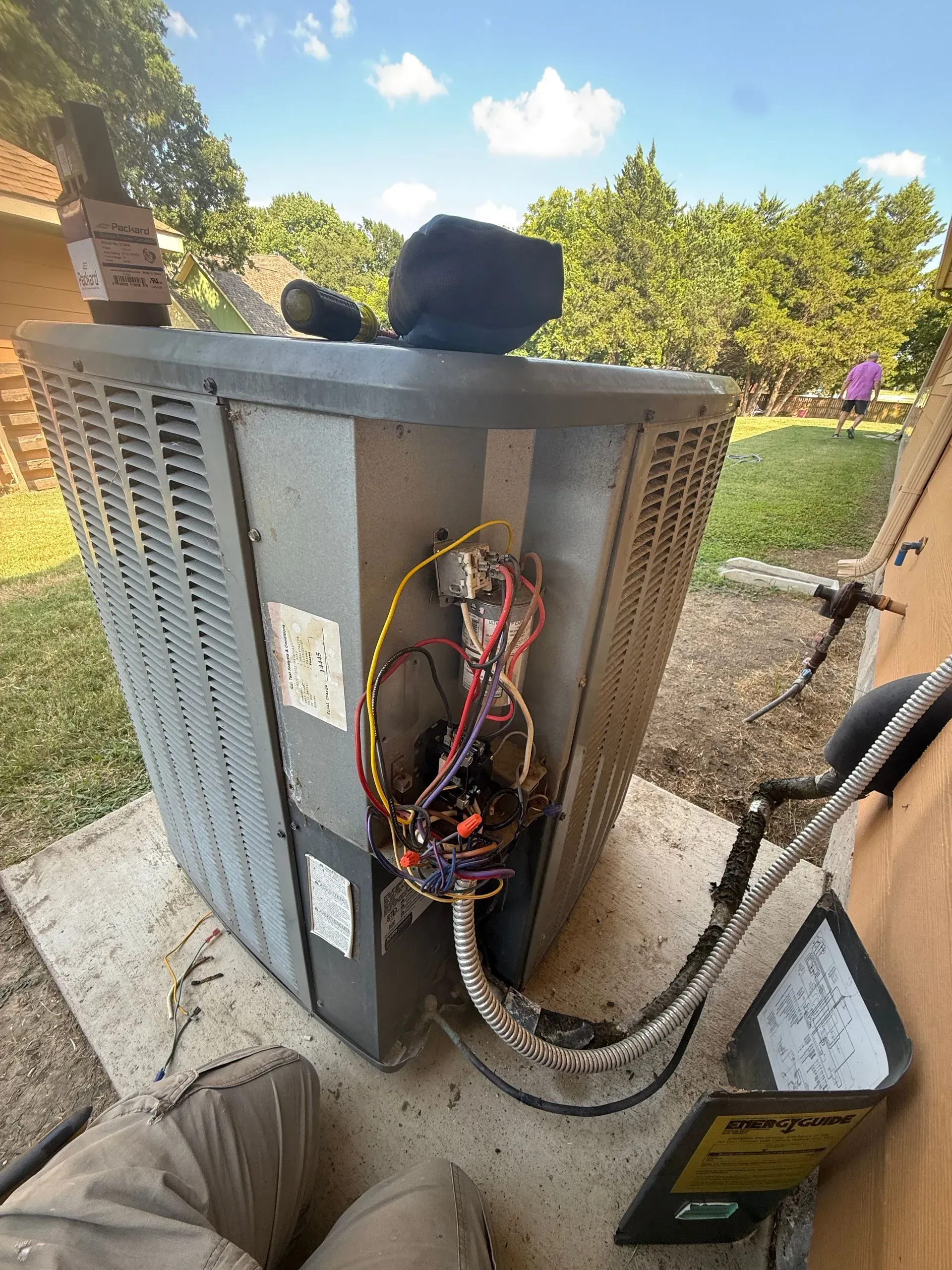 Open electrical utility cabinet with exposed wiring and cables outdoors.