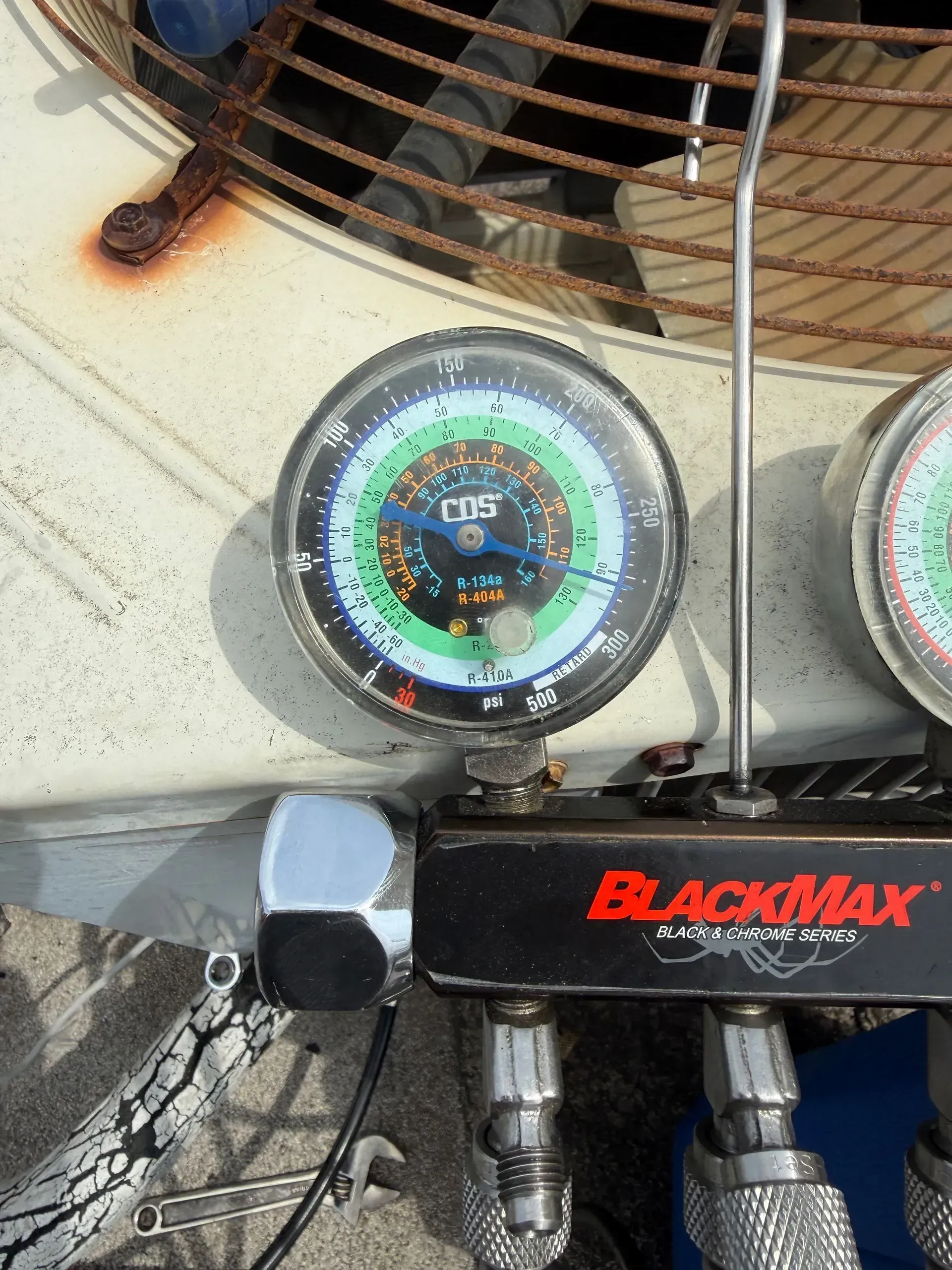 Blackmax gauge mounted on HVAC equipment with fan and wiring in the background