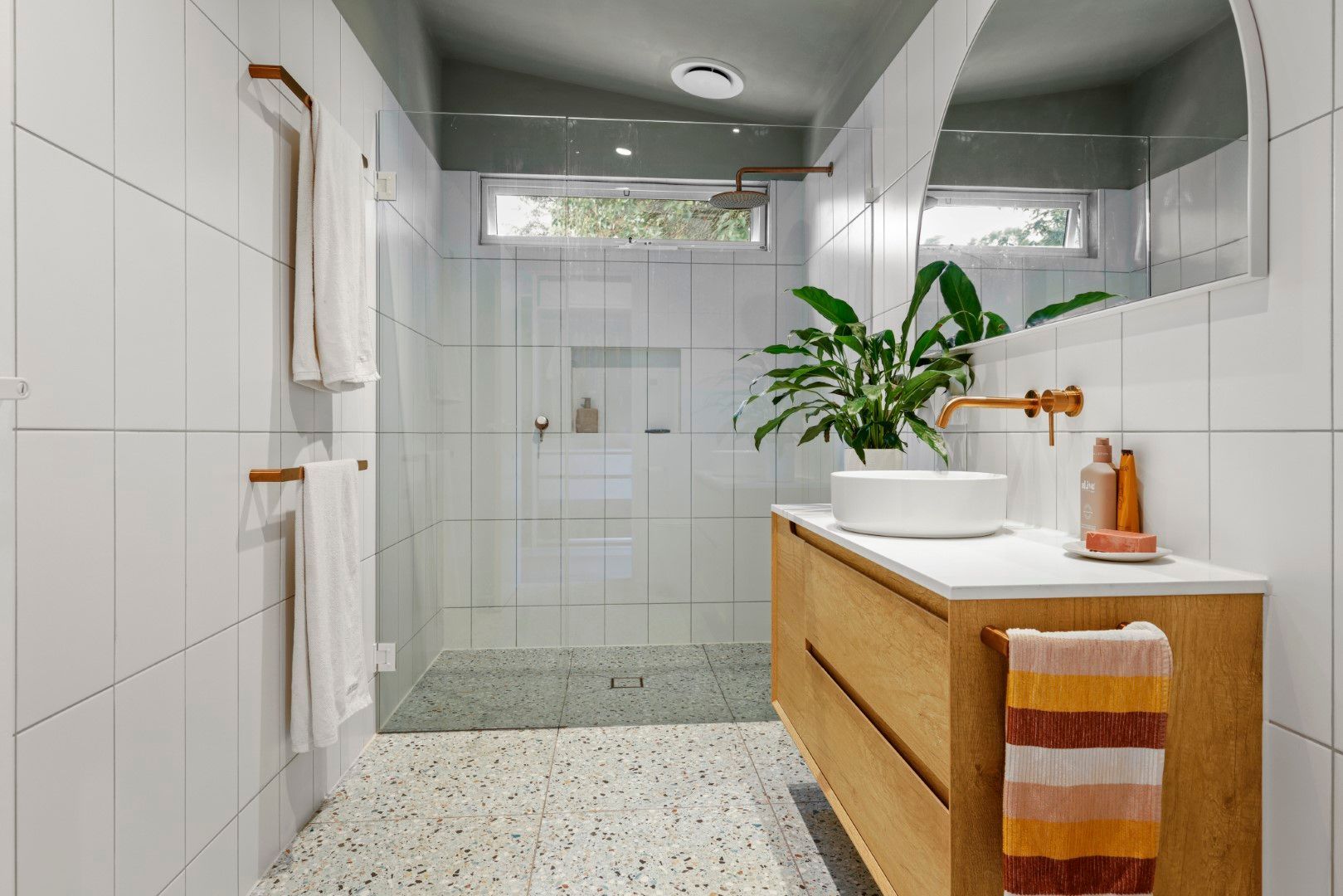 Terrazzo tiles & oak timber cabinetry with brushed brass tapware in Balnarring