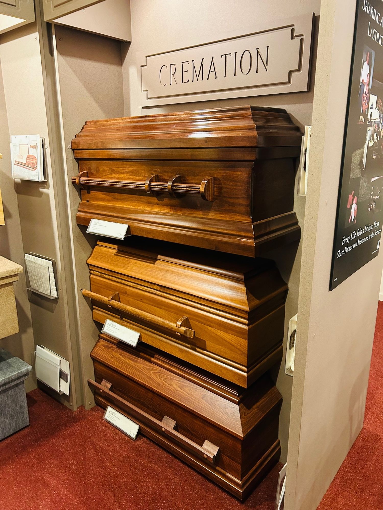 Wooden caskets stacked in a display, with a