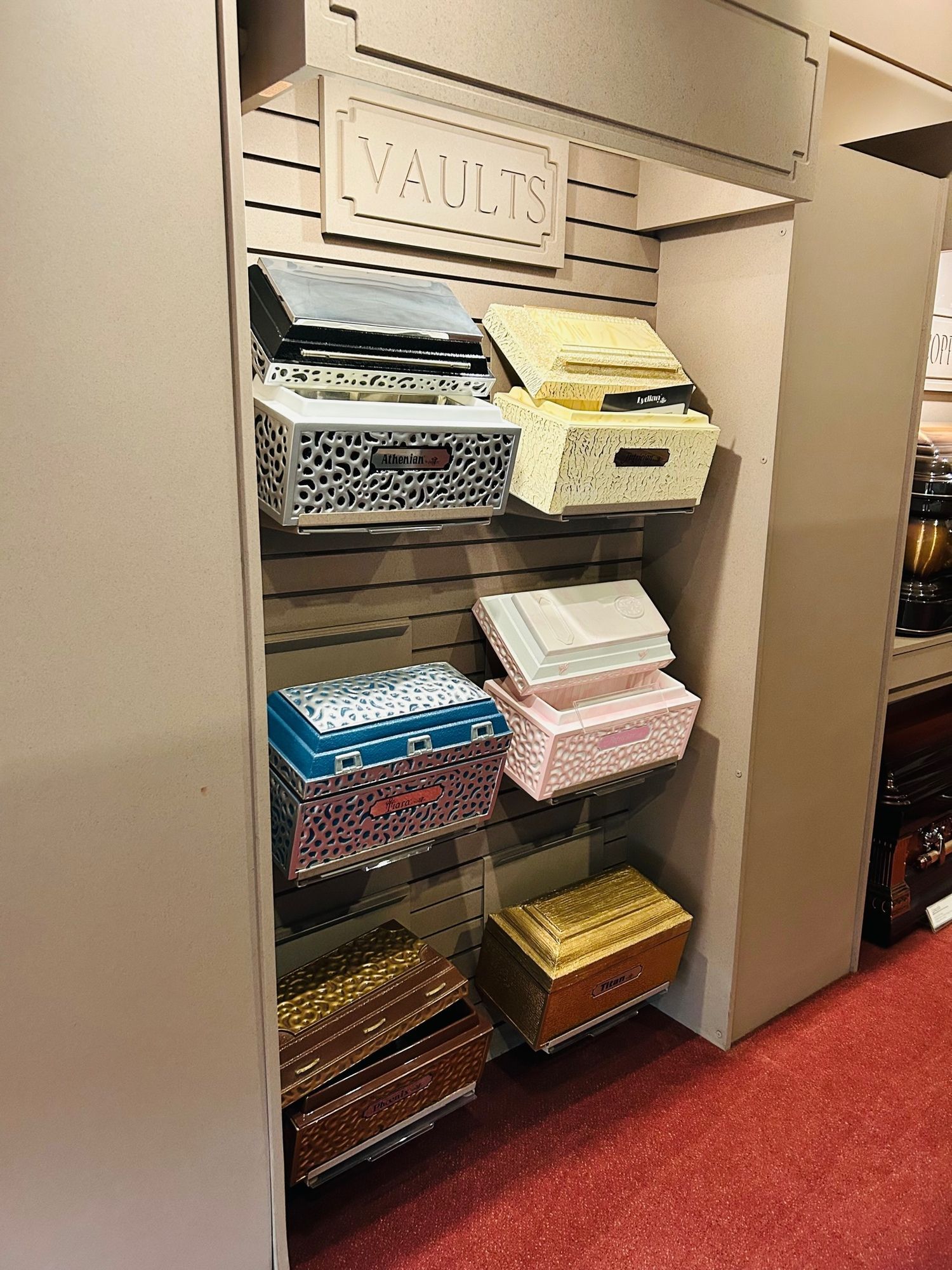 Display of colorful vaults on shelves in a store, with a
