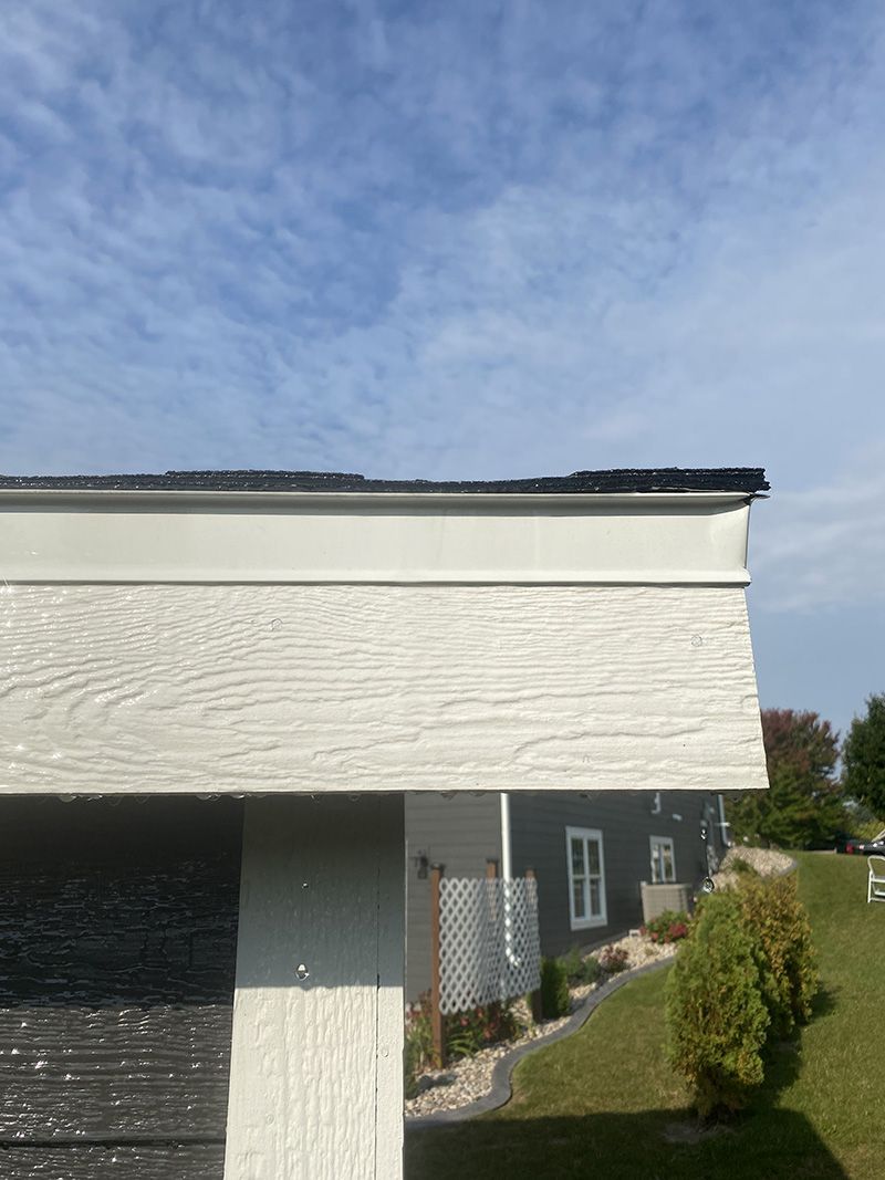 a clean concrete walkway leading to the front door of a house