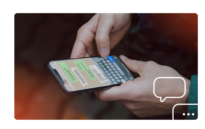 Uma pessoa está digitando em um celular com um teclado.