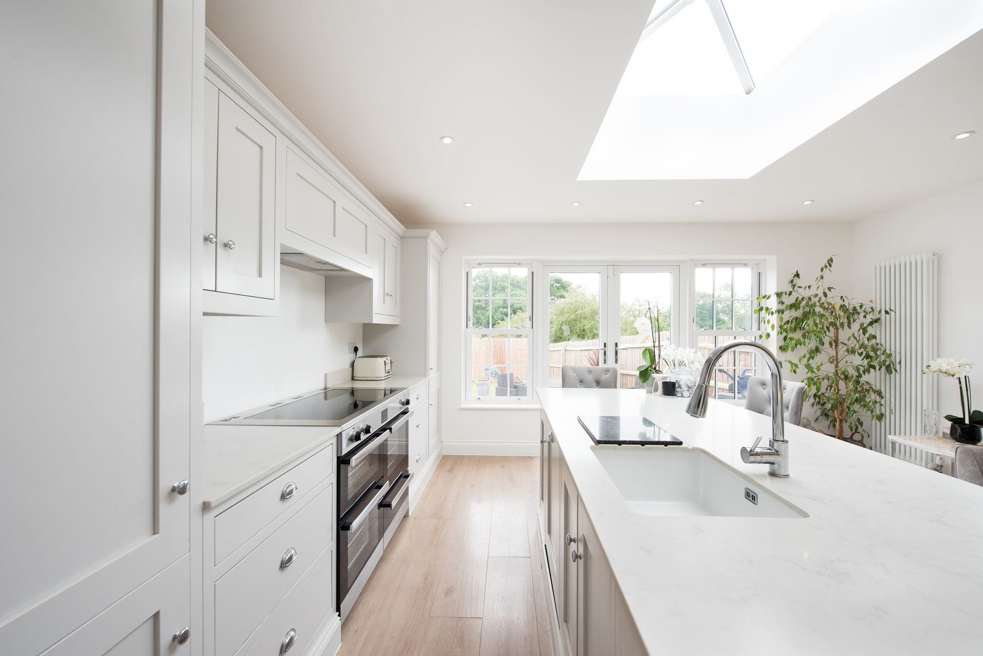 A Kitchen with White Cabinets , a Sink , a Stove , and A Skylight - Atlanta, GA - Dachi Mechanical