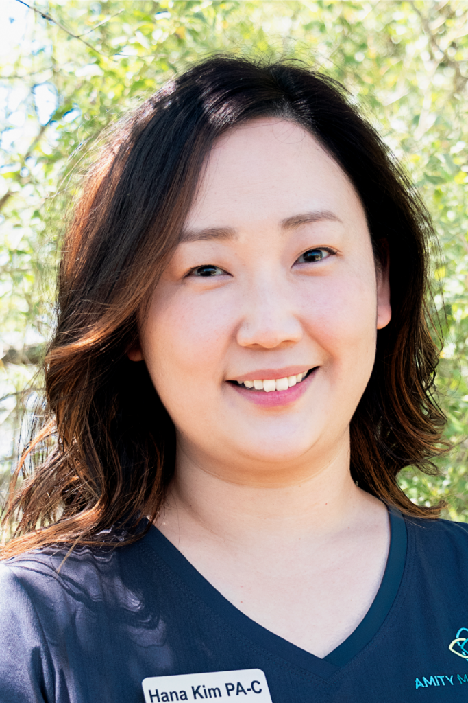 A woman in a blue shirt is smiling for the camera.