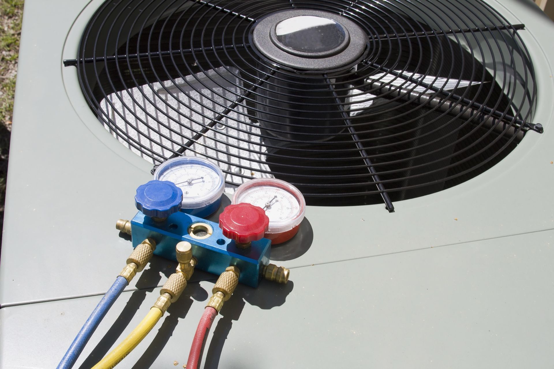 Looking through the vents of an AC unit a fan blade stays motionless
