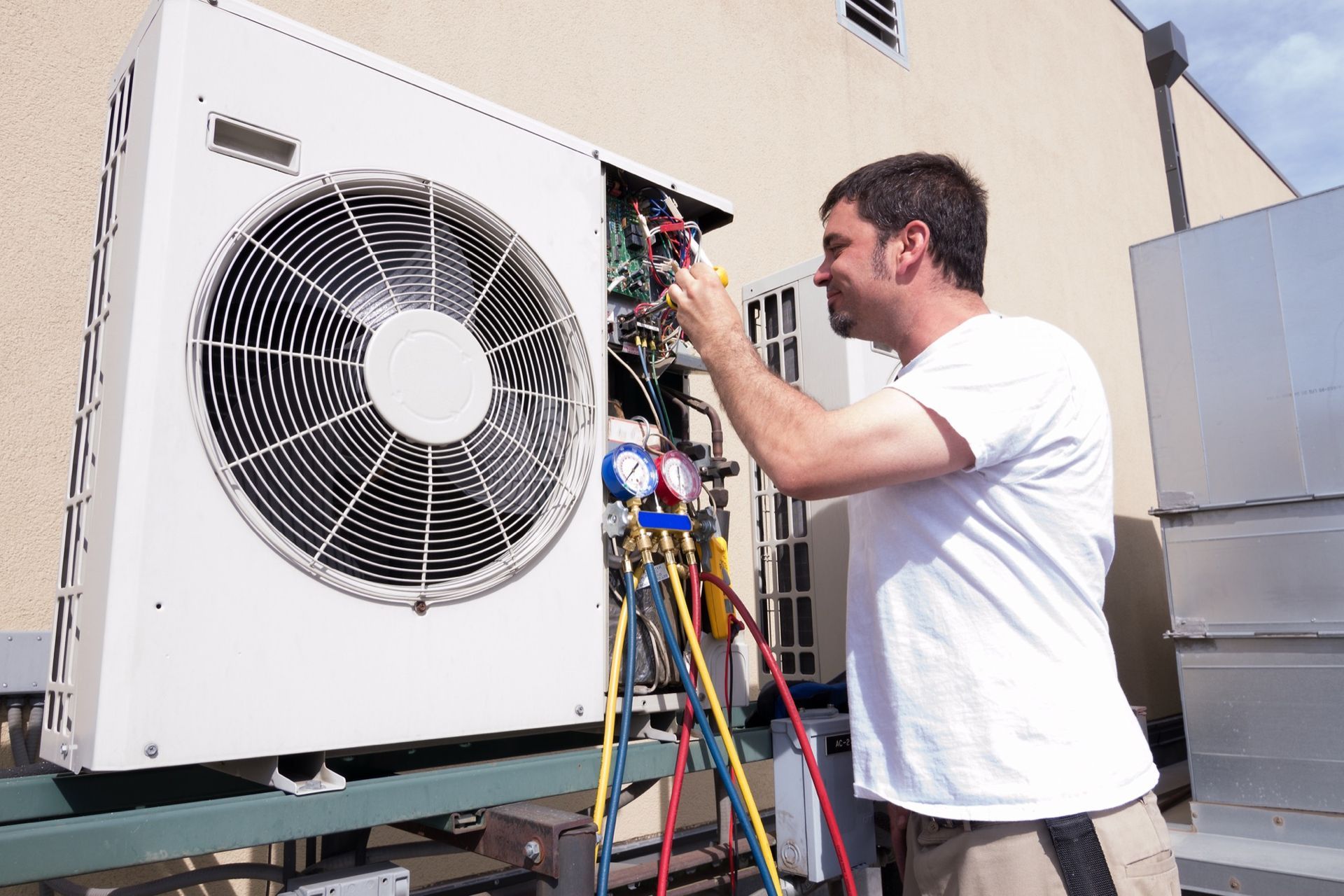 Looking through the vents of an AC unit a fan blade stays motionless