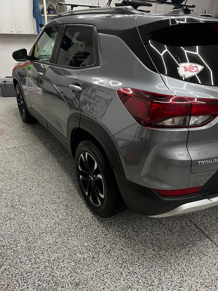 A gray suv is parked in a garage.