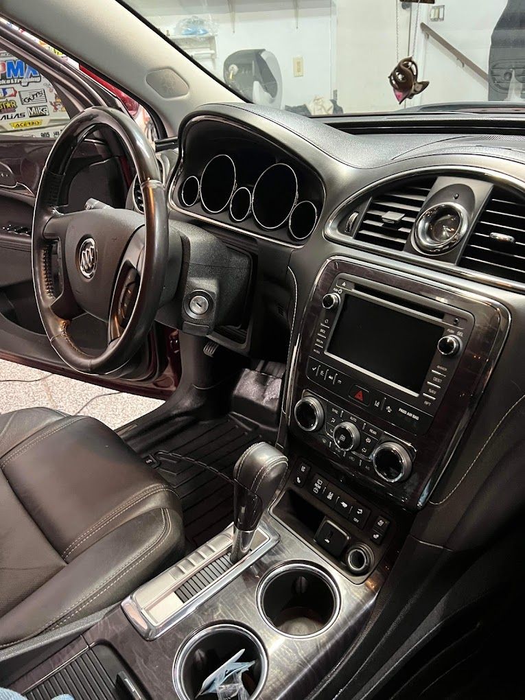 The interior of a car with a steering wheel and dashboard