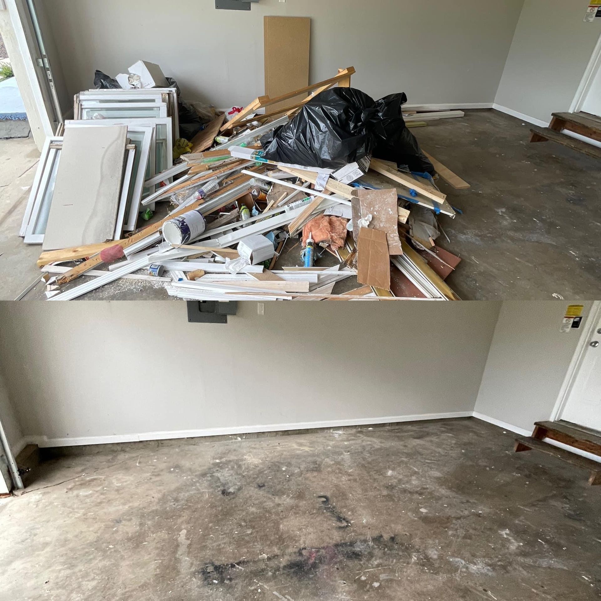 Piled construction debris and broken boards on a concrete floor in an empty room.