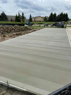 A concrete driveway is being built in a residential area.