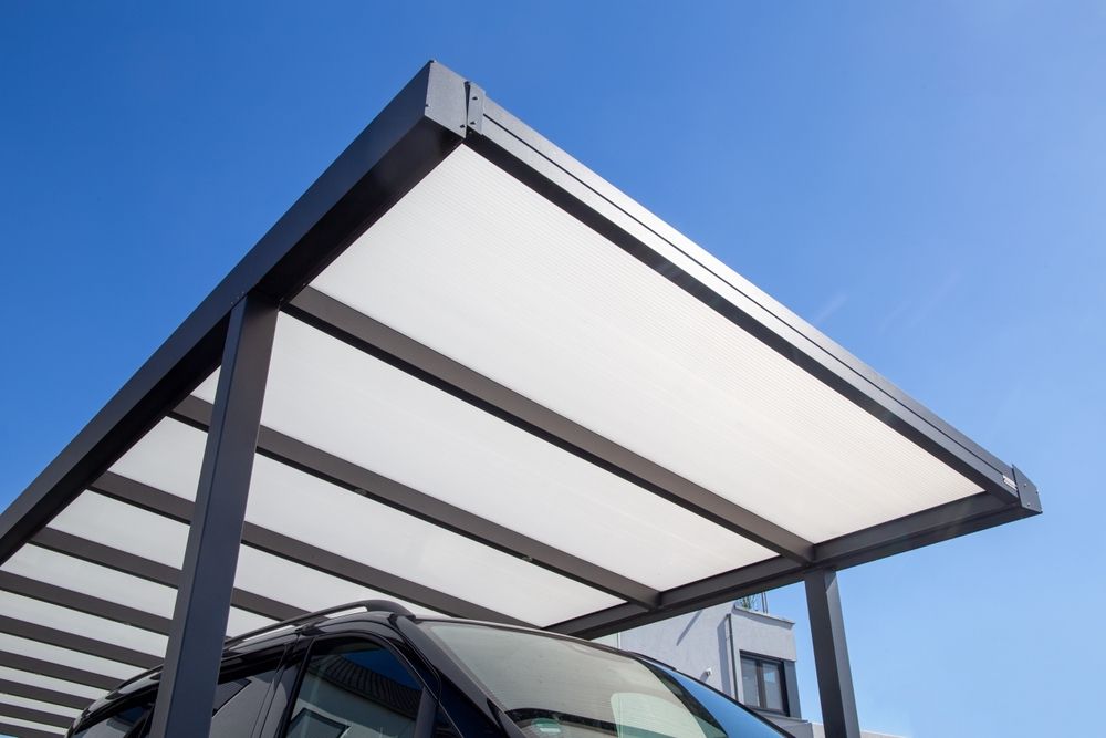 A Car is Parked Under a Canopy With a Blue Sky in the Background — Hunter & Mid Coast Patios In Hamilton, NSW