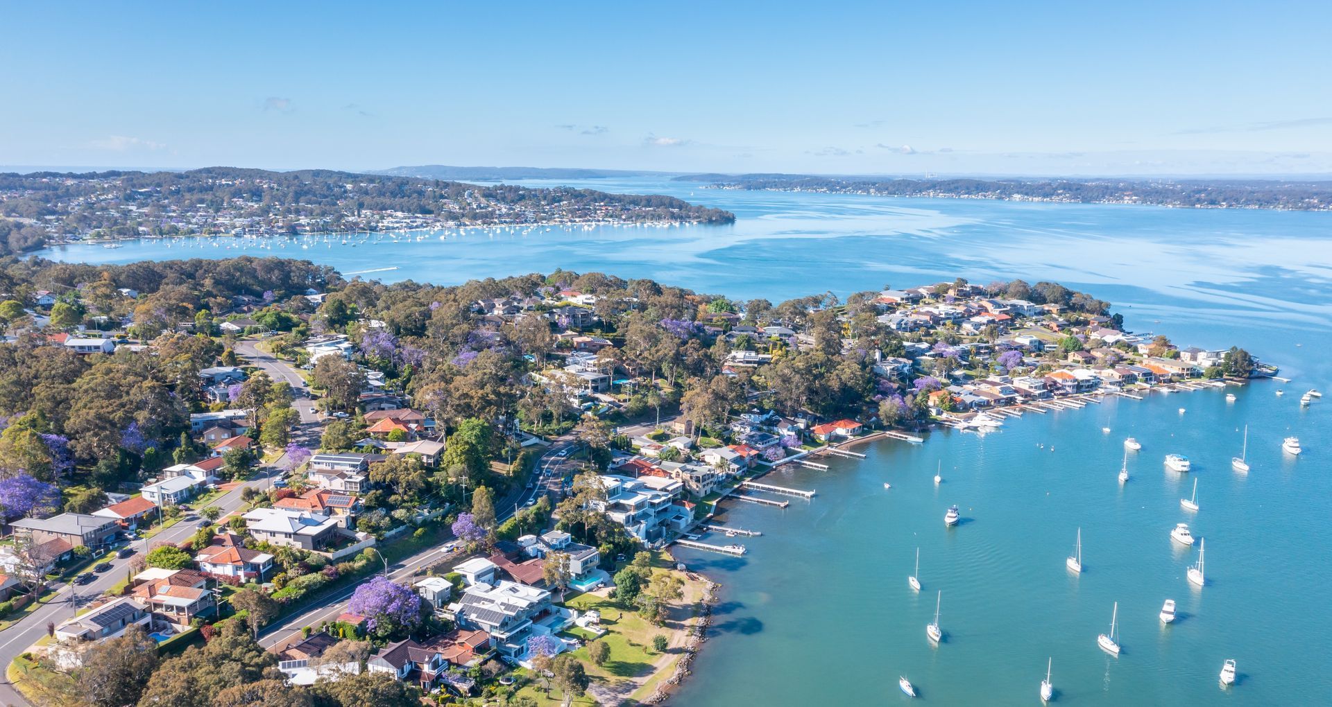 An Aerial View of a Residential Area Next to a Body of Water — Hunter & Mid Coast Patios In Lake Macquarie, NSW