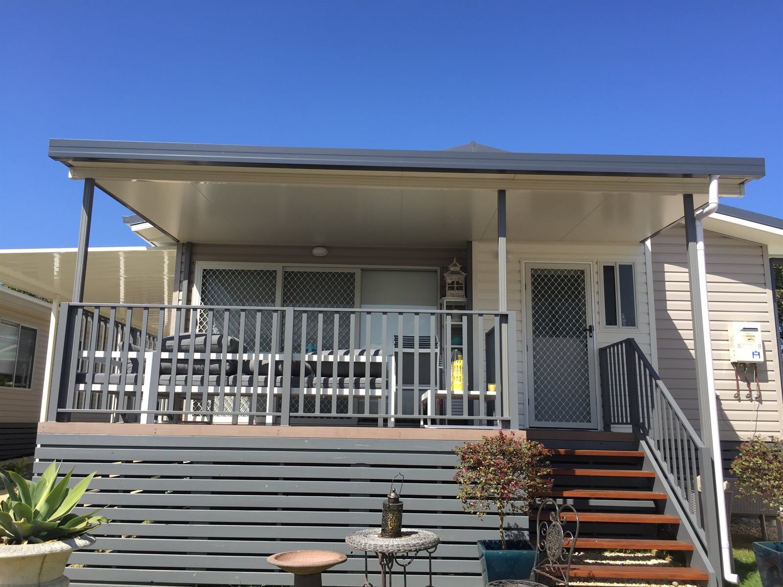 A House With a Porch and Stairs Leading Up to It — Hunter & Mid Coast Patios In Hamilton, NSW