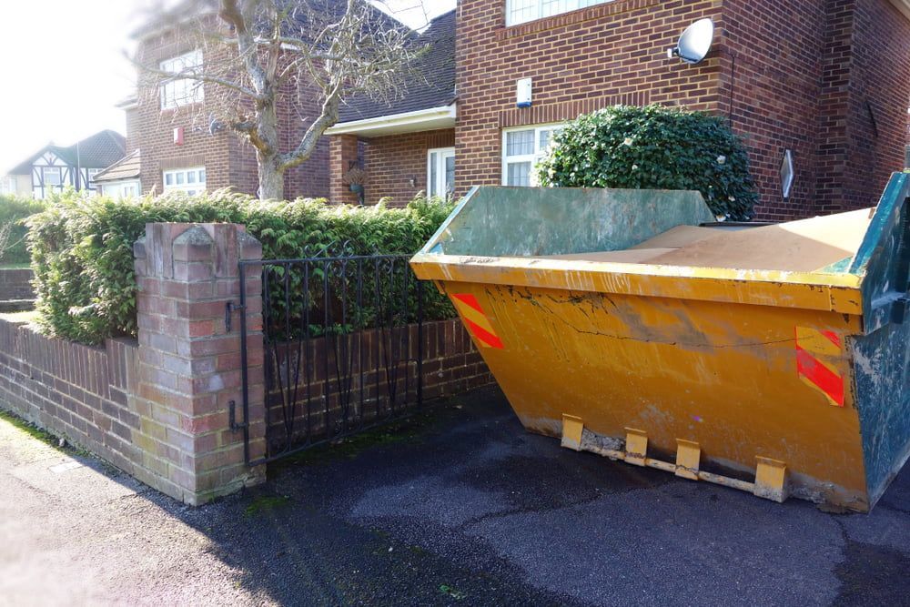 Yellow Rubbish Skip On Driveway — Gardners Yamba Skip Bin Hire In South Grafton, NSW