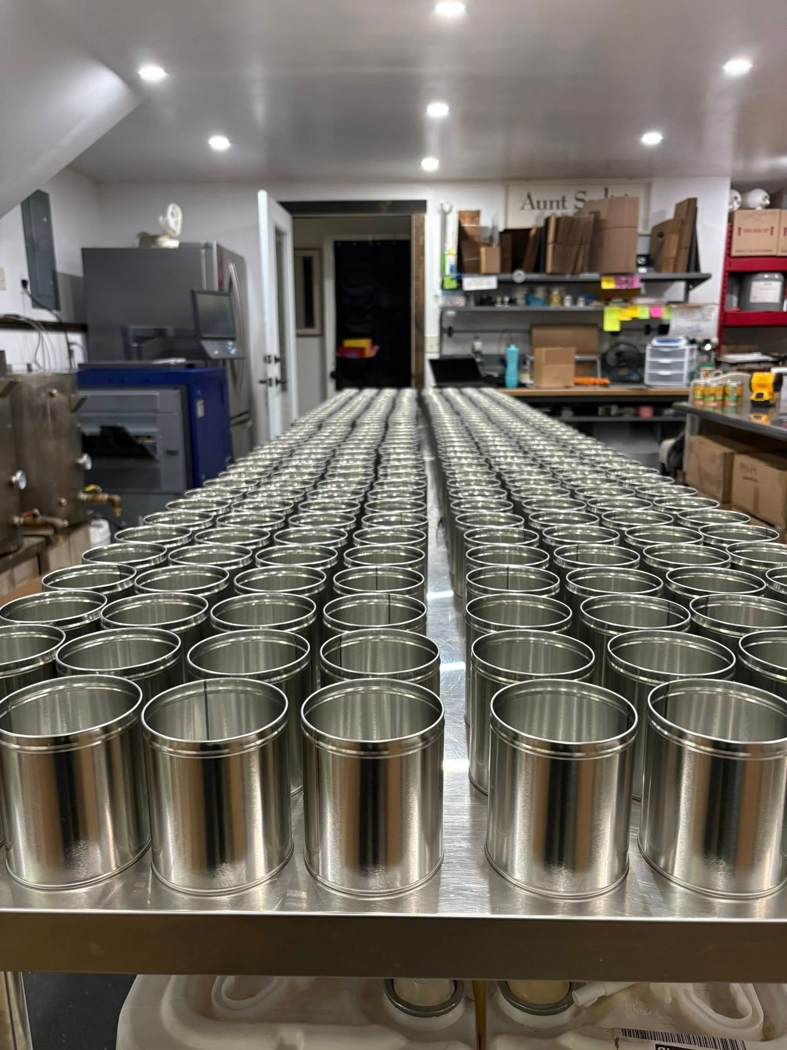 Candle tins lined up and ready to be poured in the Aunt Sadie's Candles workshop