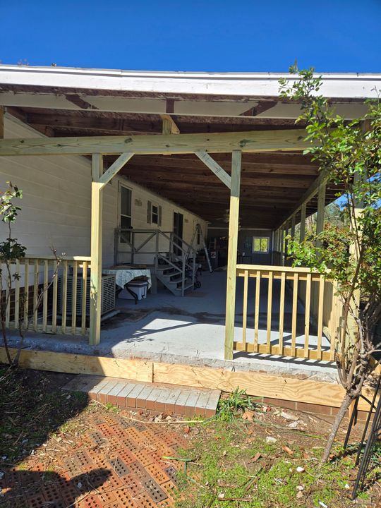A ladder is sitting in front of a house under construction.