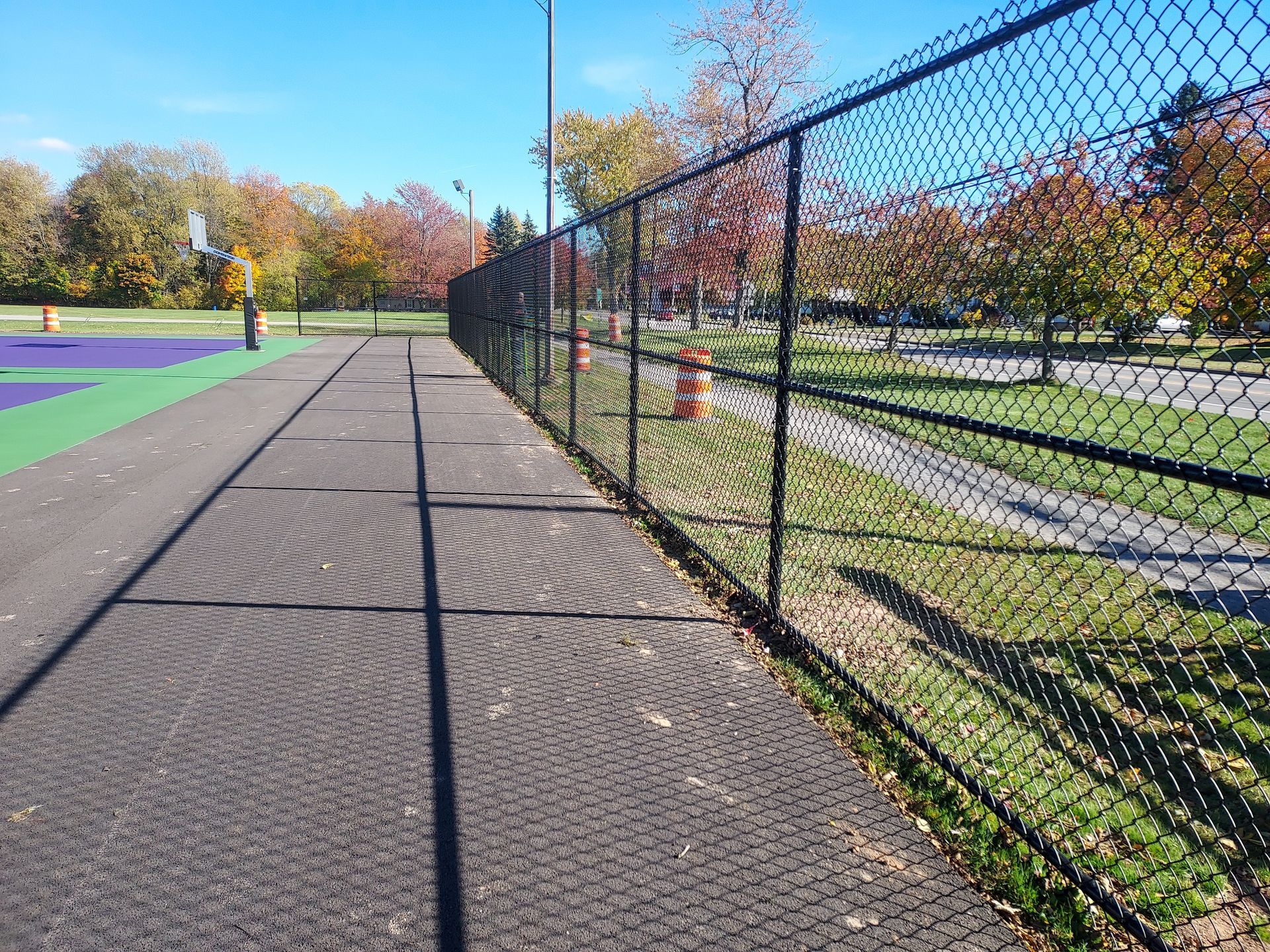 A chain link fence with a warehouse in the background