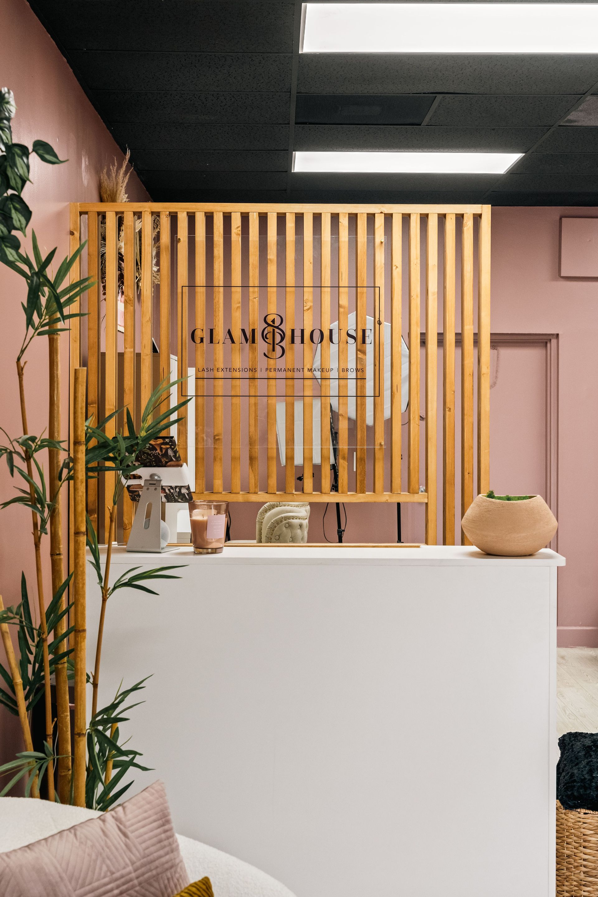 A reception desk in a room with a wooden divider.