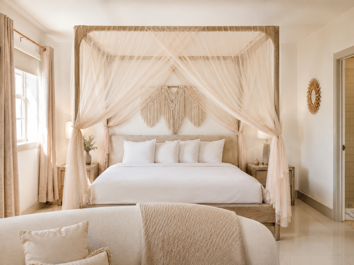 Elegant bedroom with a canopy bed, sheer curtains, and neutral beige decor