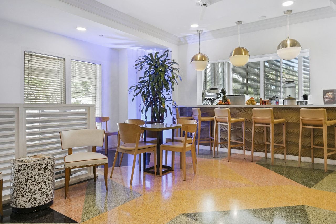 Breakfast area with bar seating and tall shuttered windows