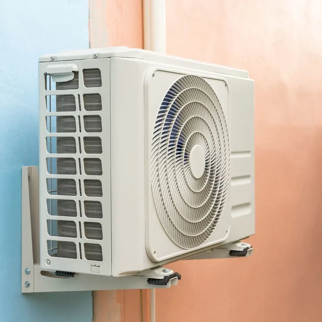 Outdoor ductless mini-split compressor mounted on a wall bracket Outdoor ductless mini-split compressor mounted on a wall bracket