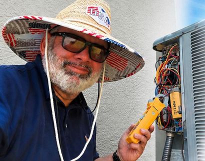 Technician beside HVAC unit with gauges and tools, James Heating & Air branding and call number.