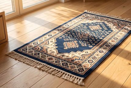 Blue and cream patterned rug on a sunlit wooden floor near a window