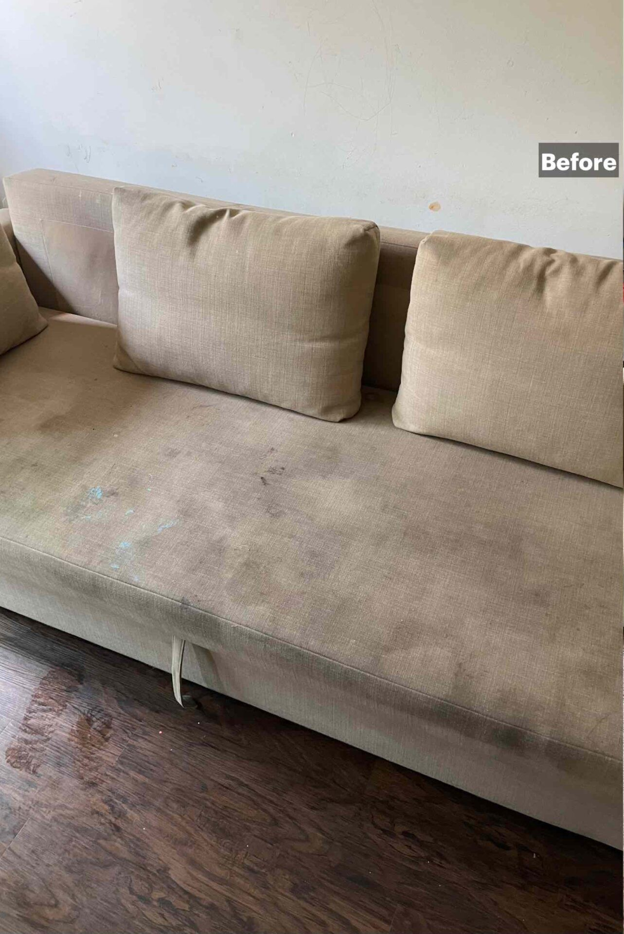 Beige sofa with cushions and a worn seat in a living room, labeled “Before”