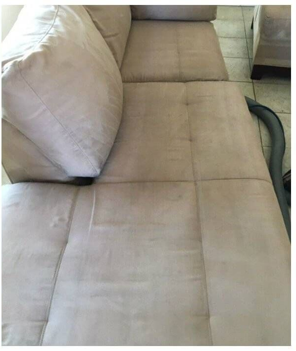 Beige sofa with large floor cushion and stitched cushions, shown in a close-up indoors