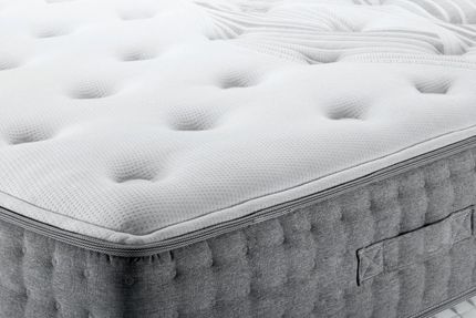 White quilted mattress top with gray side panel in close-up