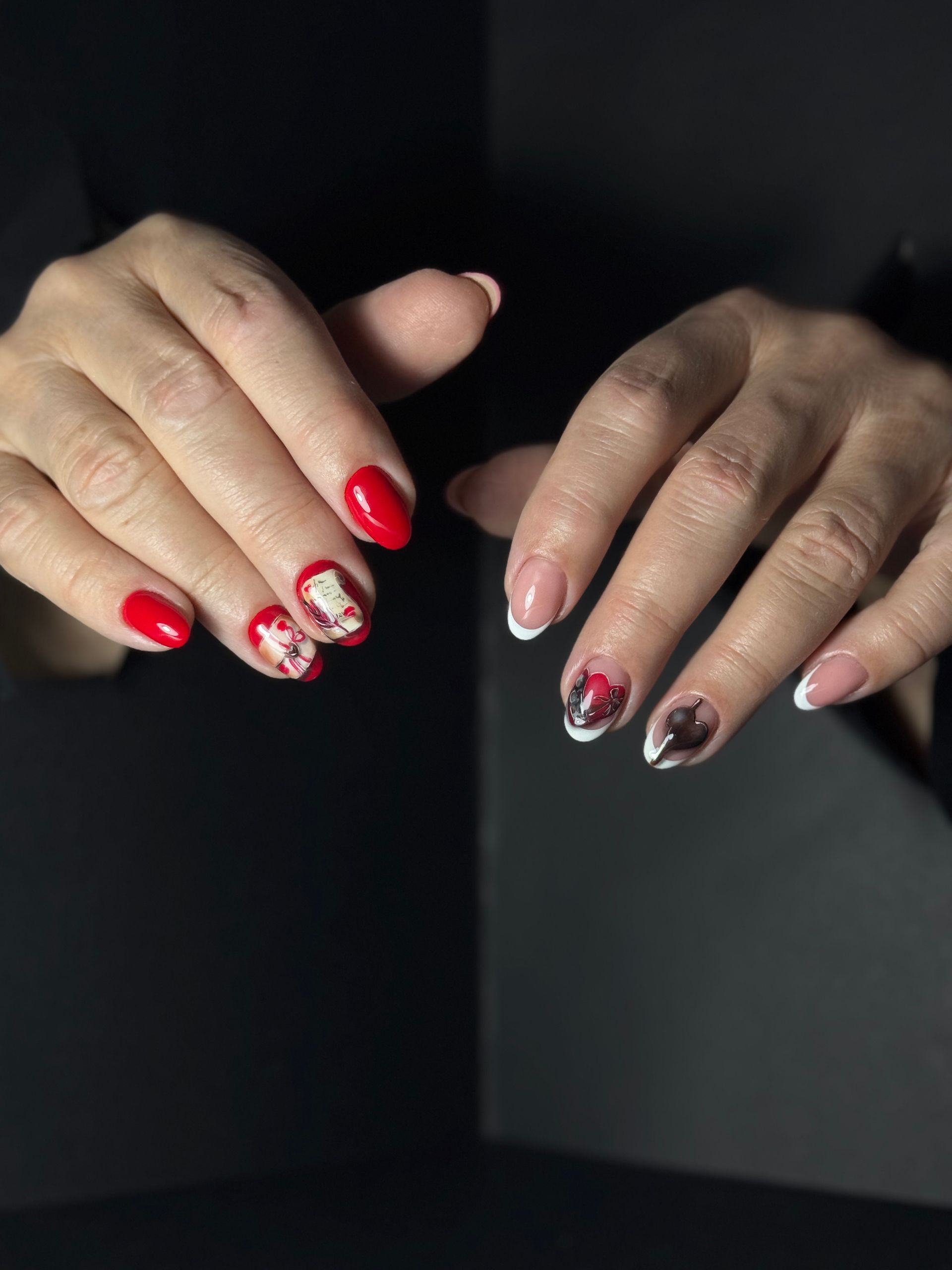 Red and white floral nail art on long, square-shaped nails.