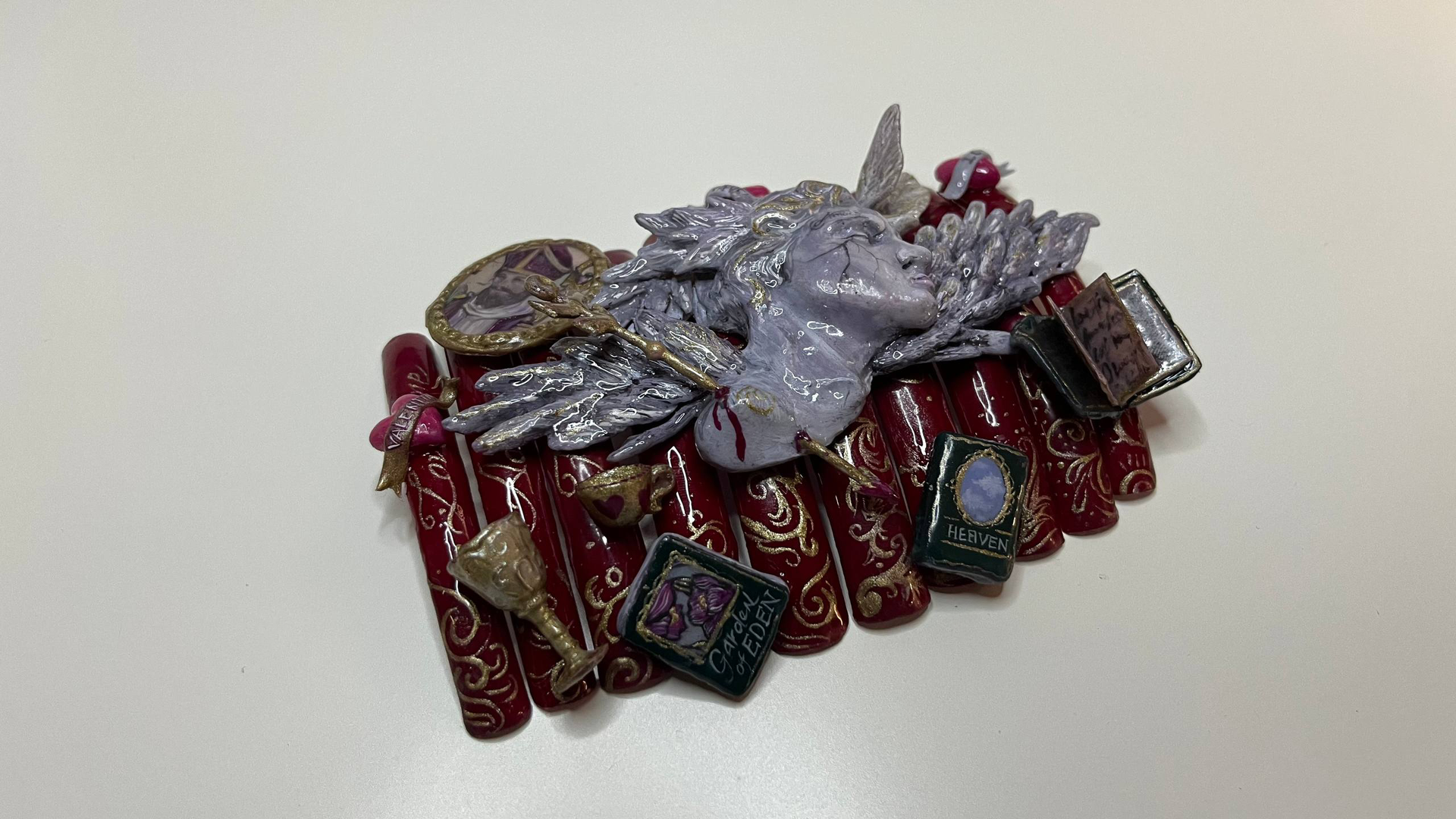 Pile of assorted red and silver metallic jewelry and ornaments on a white background