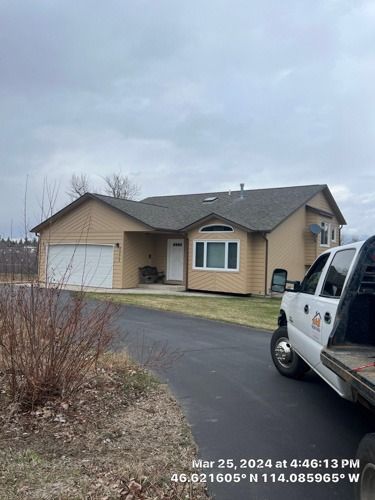 A truck is parked in front of a house.