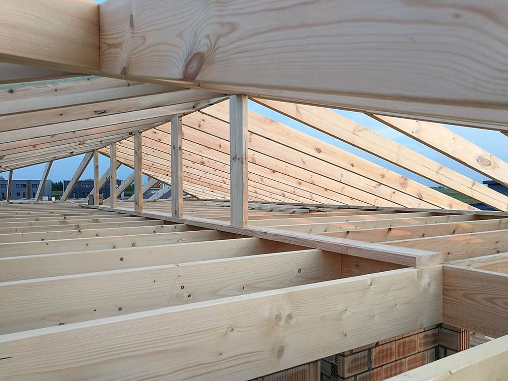 The roof of a building is being built with wooden beams