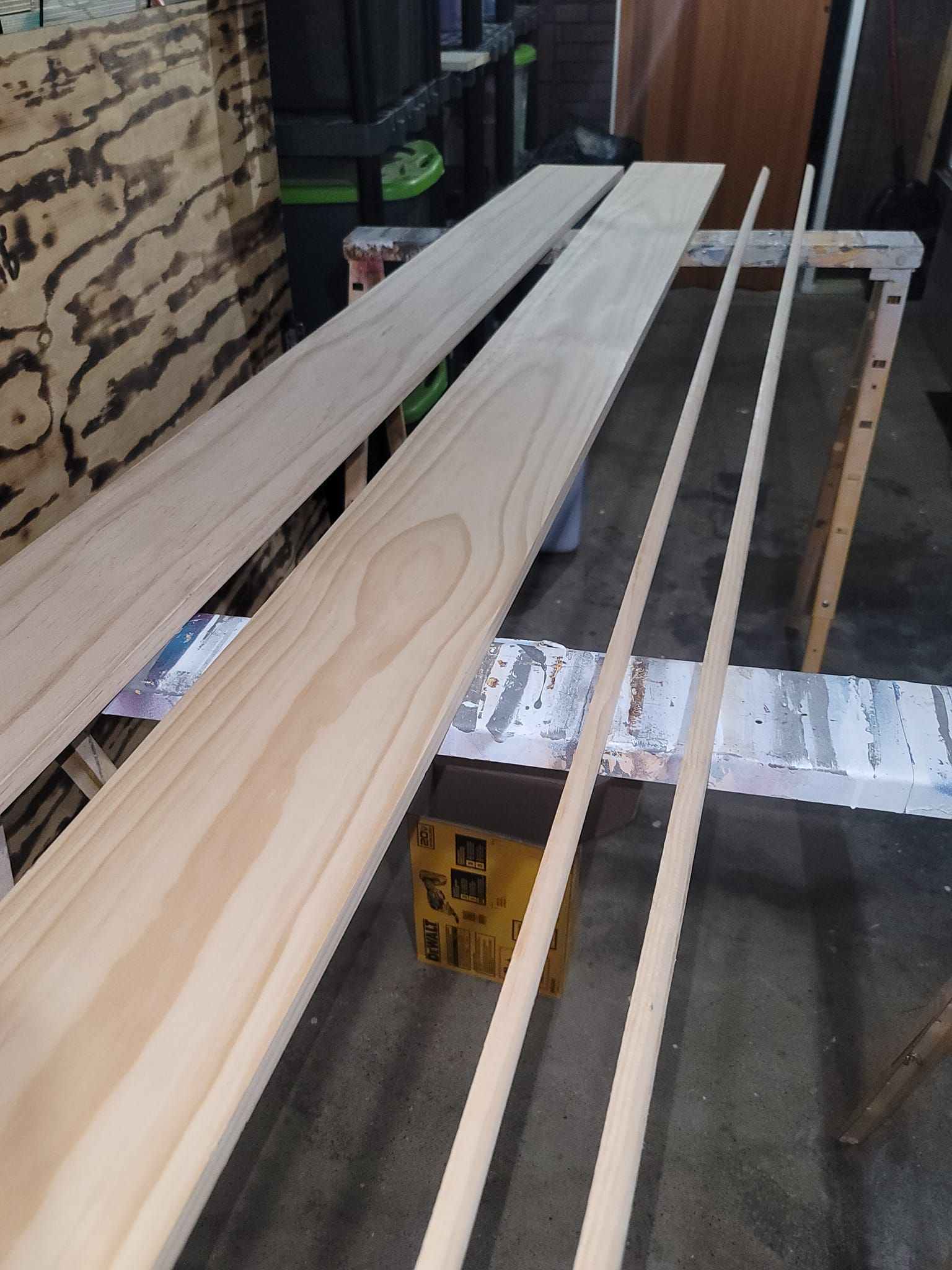 A bunch of wooden boards are sitting on top of each other on a table.