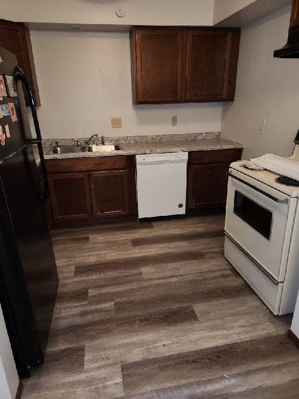 A kitchen with a refrigerator , stove , dishwasher and sink.