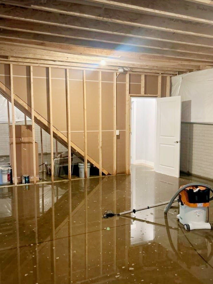 A flooded basement with a vacuum cleaner in it.