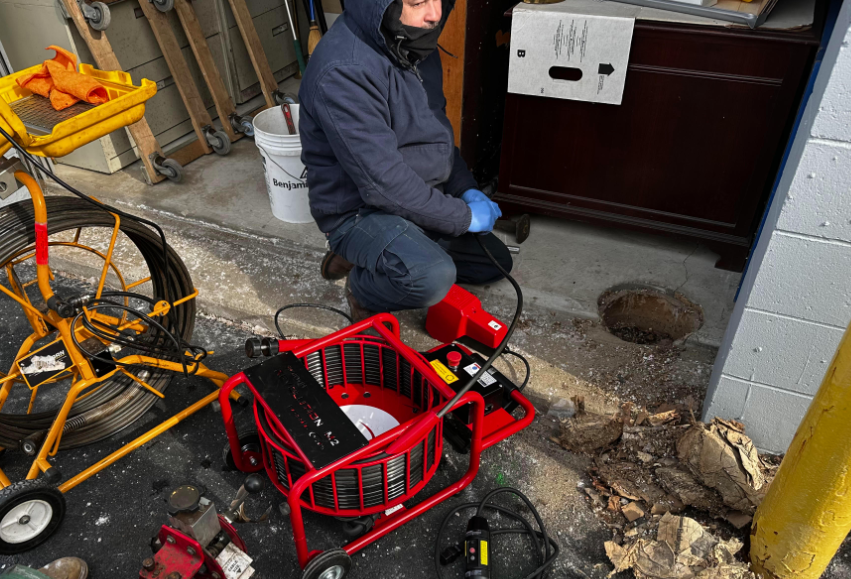 Plumber Fixing The Sink In The Kitchen Using Pipe Plunger - Framingham, MA - Rooter-Man Sewer & Drain Service Plumber Fixing The Sink In The Kitchen Using Pipe Plunger - Framingham, MA - Rooter-Man Sewer & Drain Service