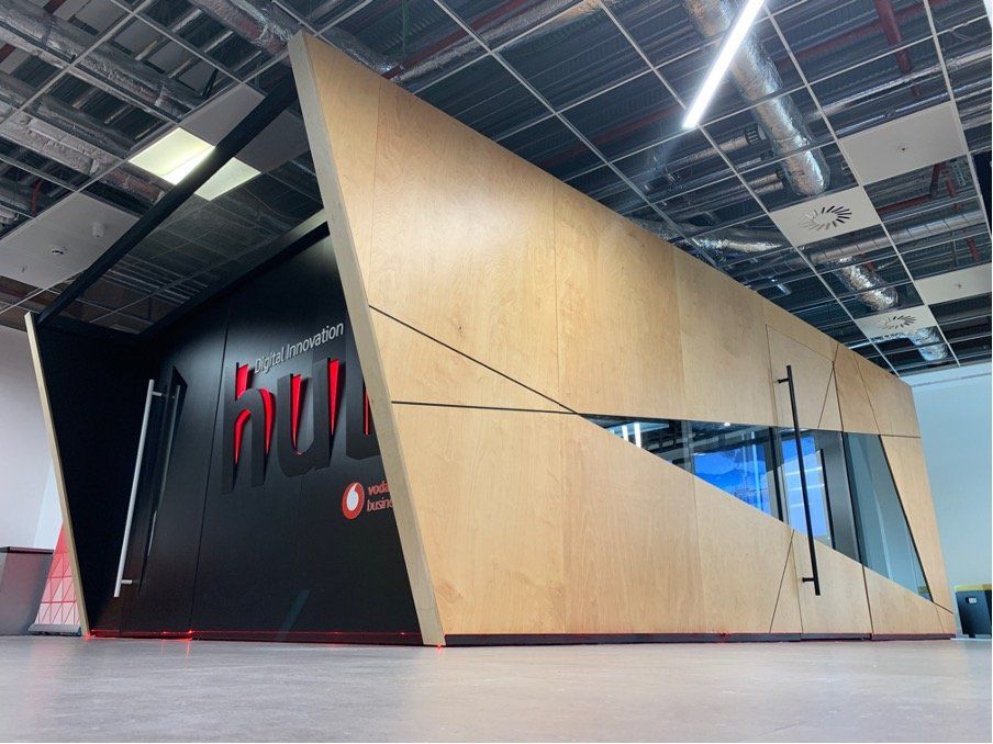 A building with a wooden wall and a sign that says ' hulk ' on it