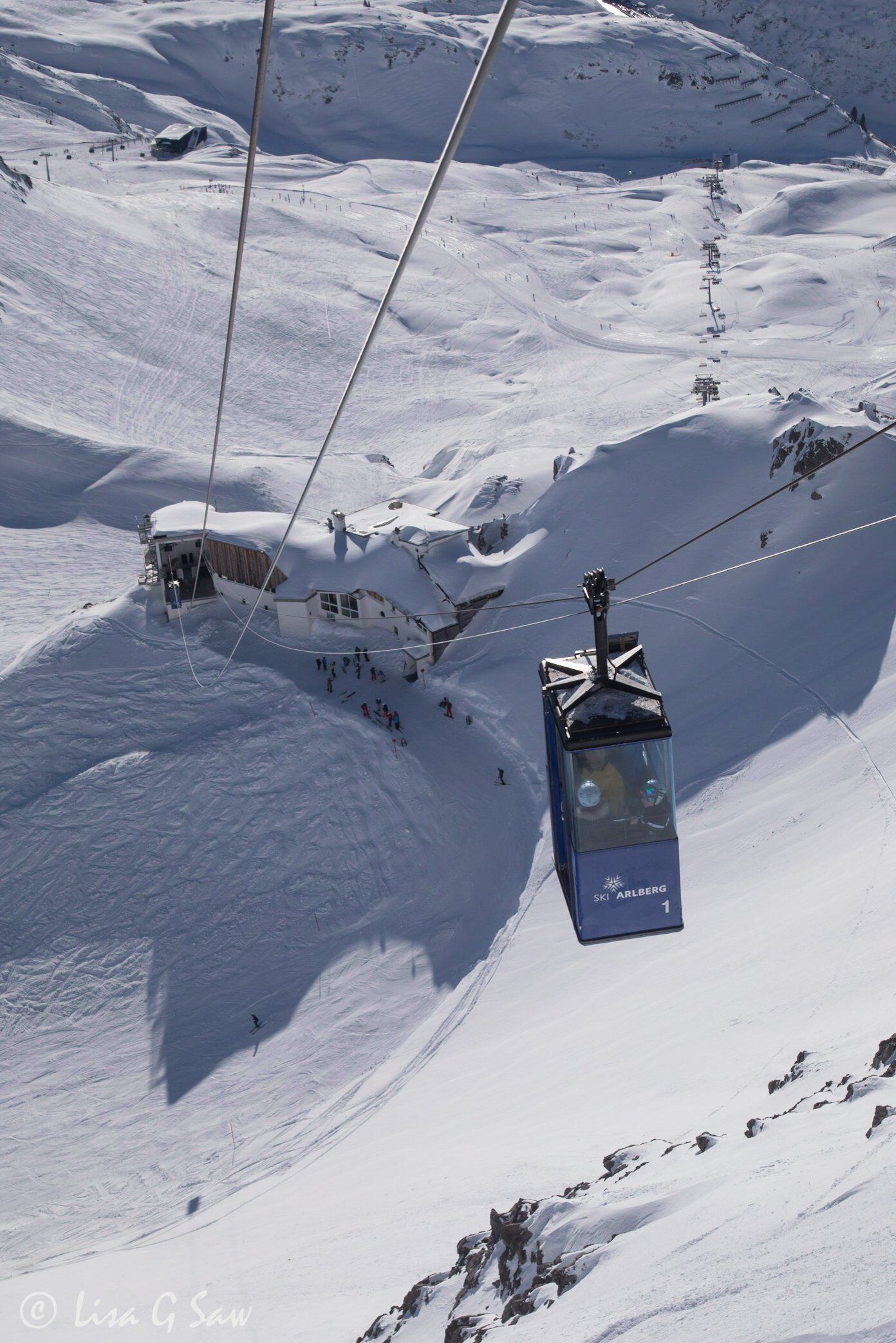 Small cable car with ski resort below
