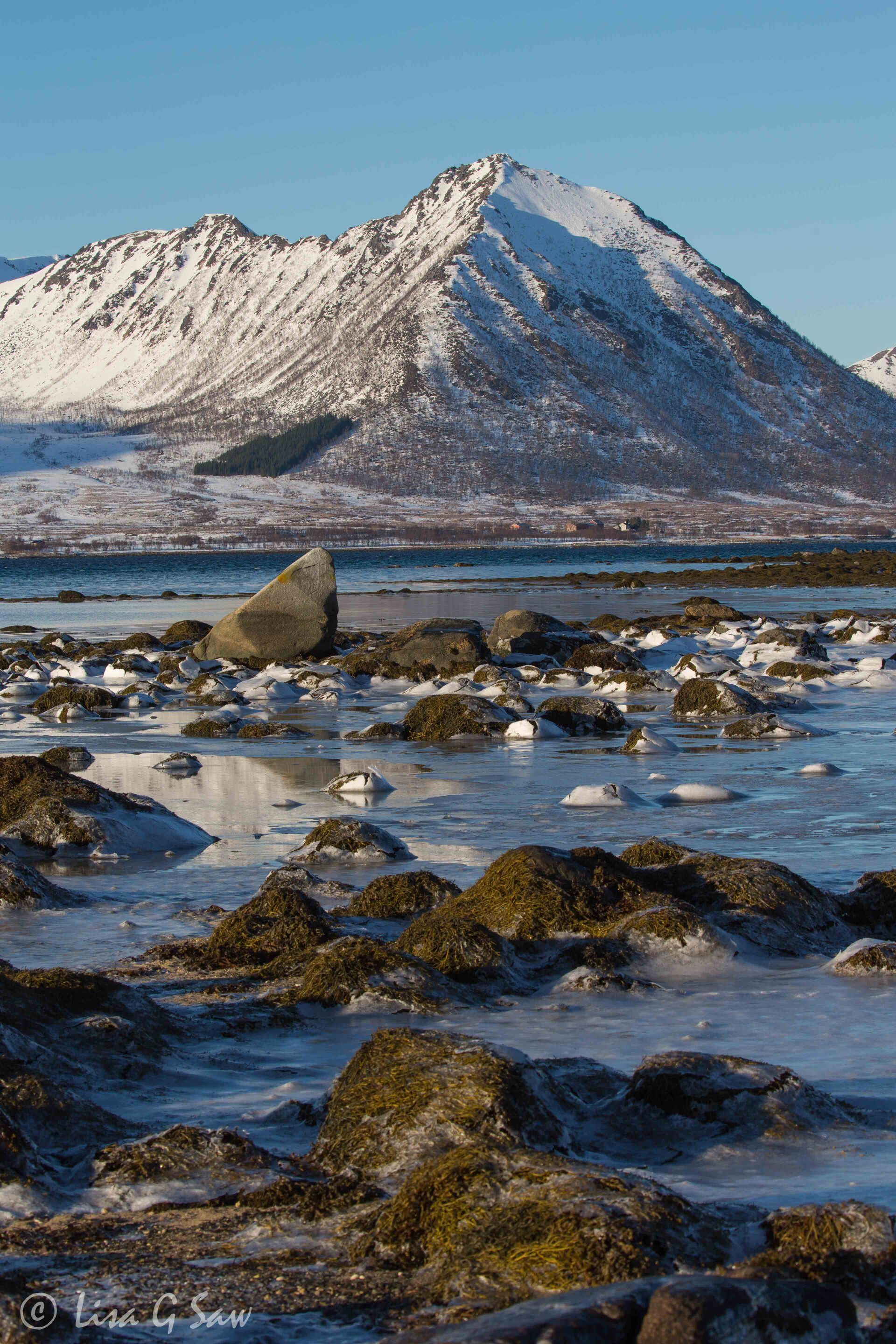 Rocks and ice with mountain in background