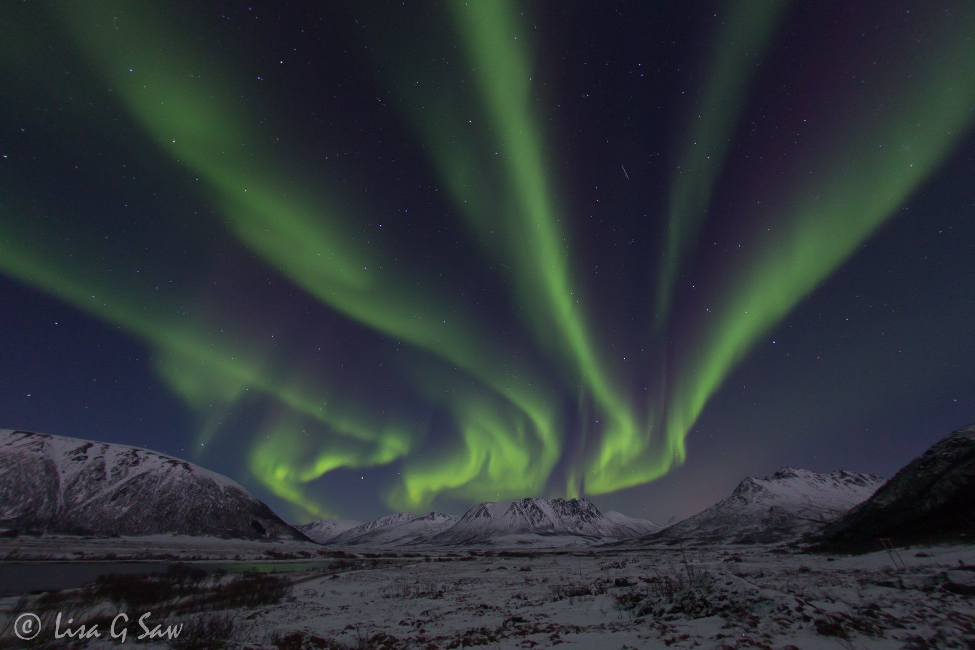 Multi bands of Northern Lights coming from mountain